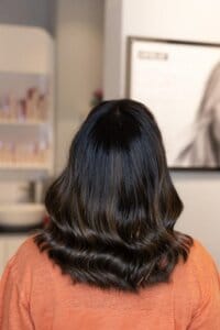 Glossy dark brunette hair, styled at Tara Rose