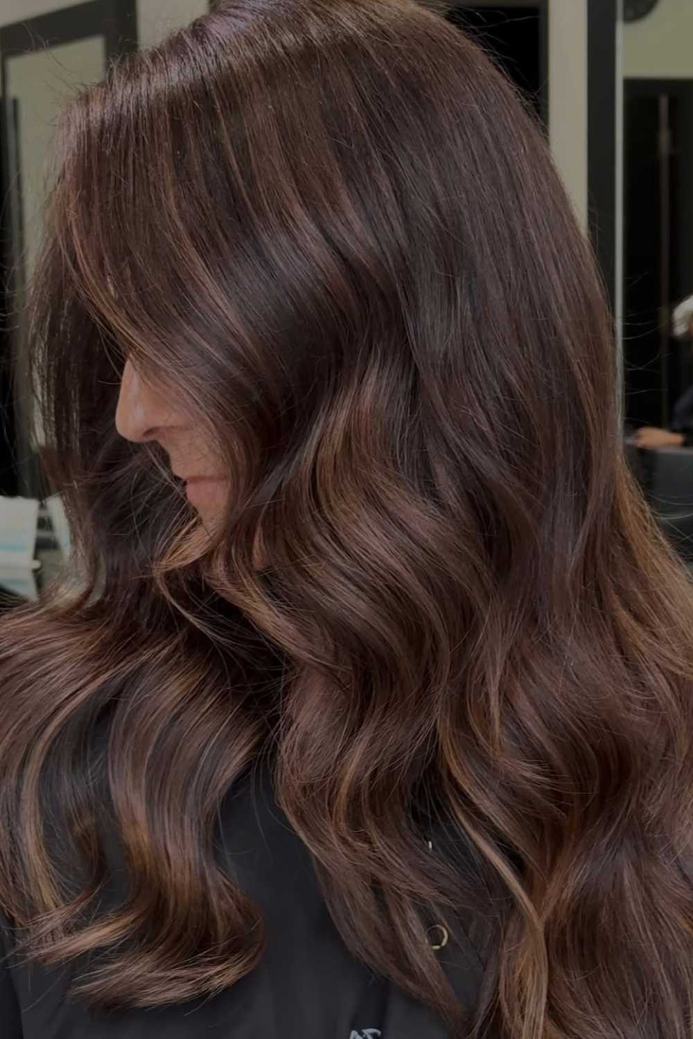 Rich brunette hair styled in soft waves