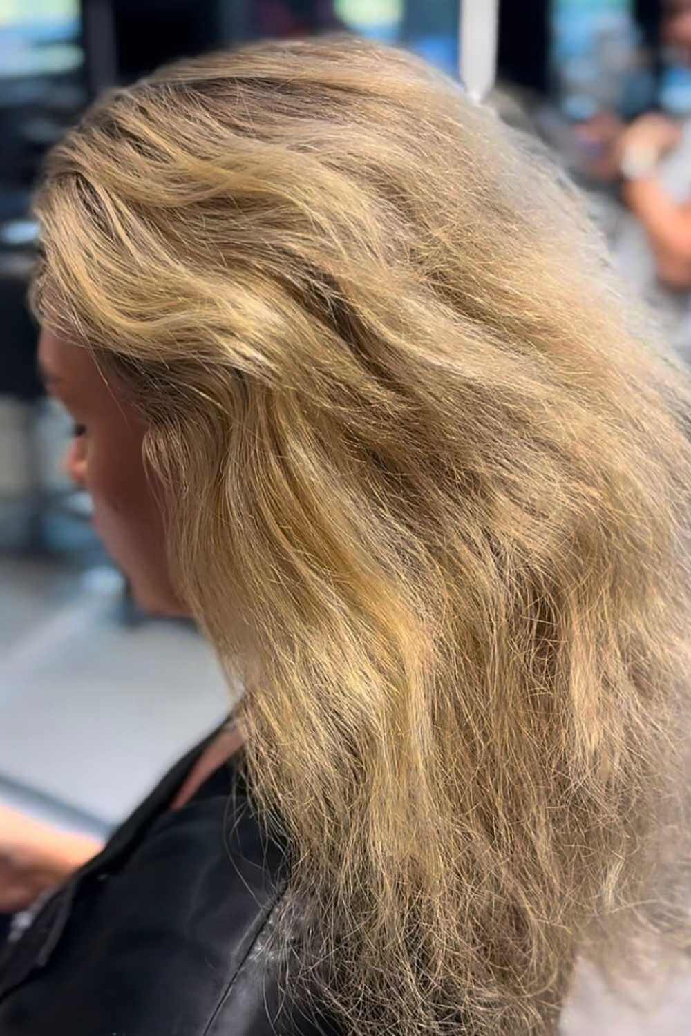 Blonde highlights lifted through mid-brown hair