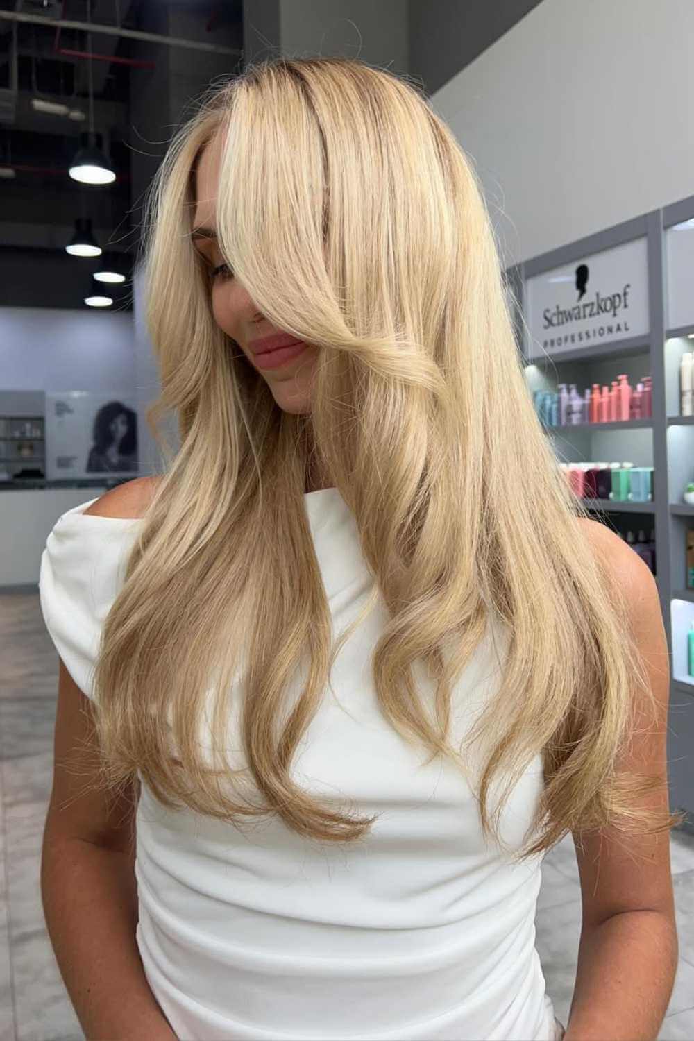 Long blonde hair styled in soft waves