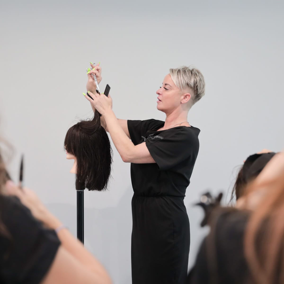 A stylist demonstrating a technique at the Tara Rose Academy